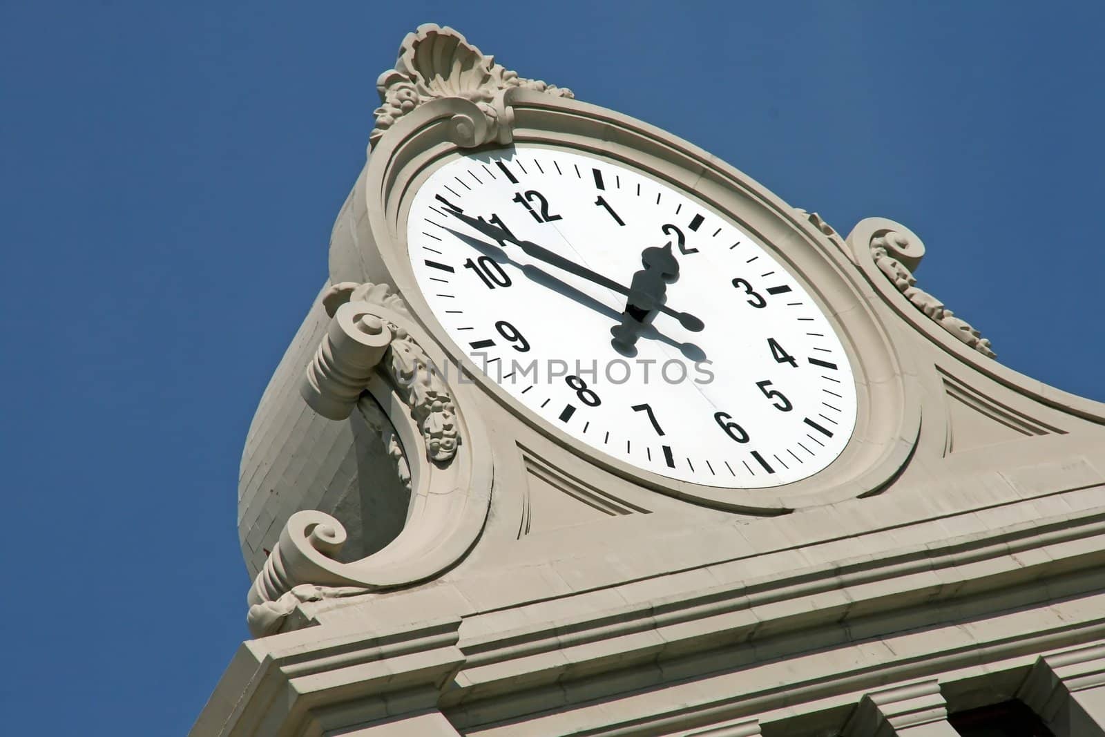 monumental clock on blue sky background