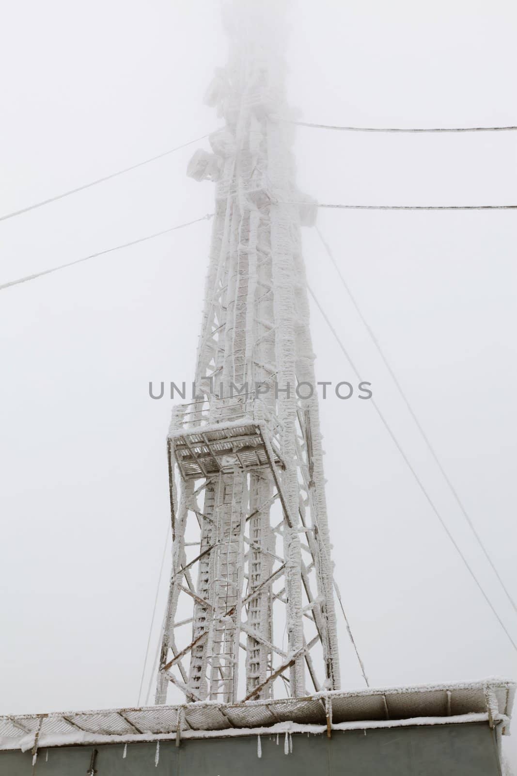 Radio transmitting tower frozen with a huge amounts of snow