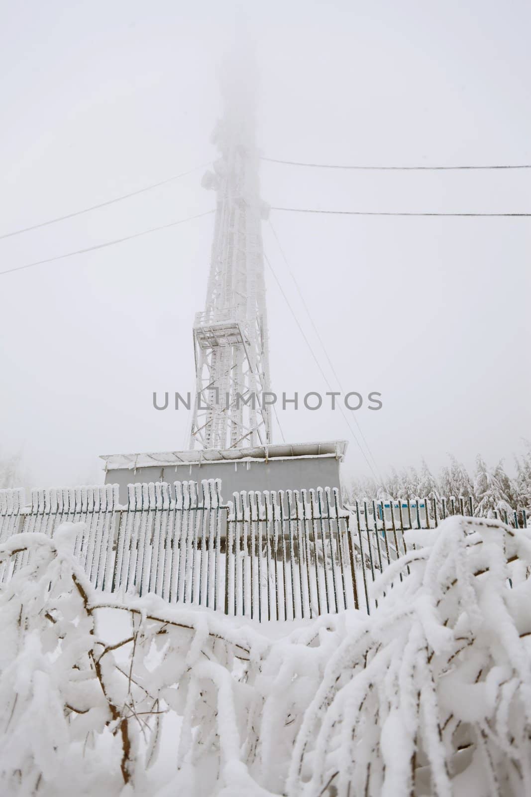 Radio transmitting tower frozen with a huge amounts of snow