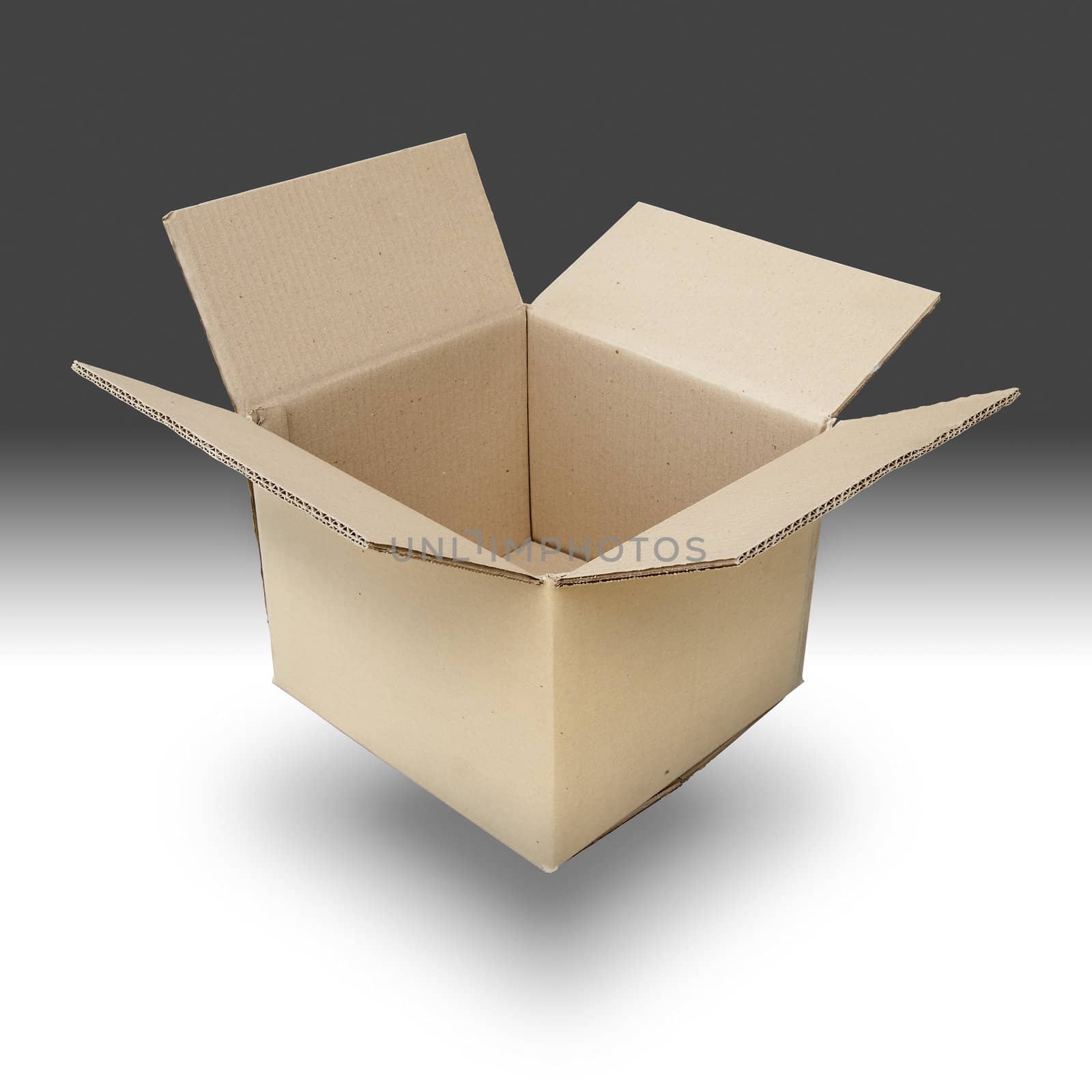 Brown paper box open on white floor and gray background