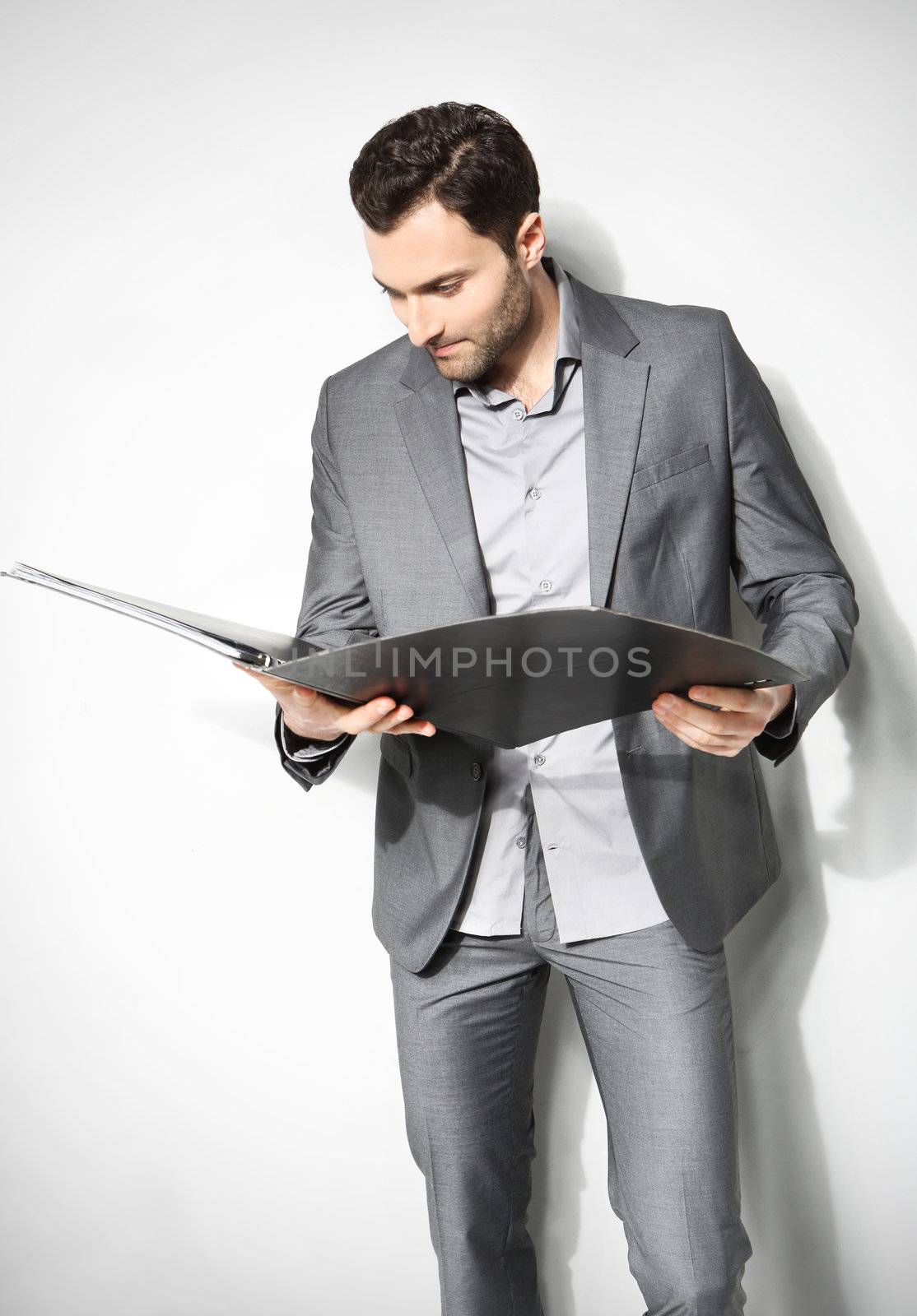 Portrait of a handsome business man ,Isolated on gray by robert_przybysz