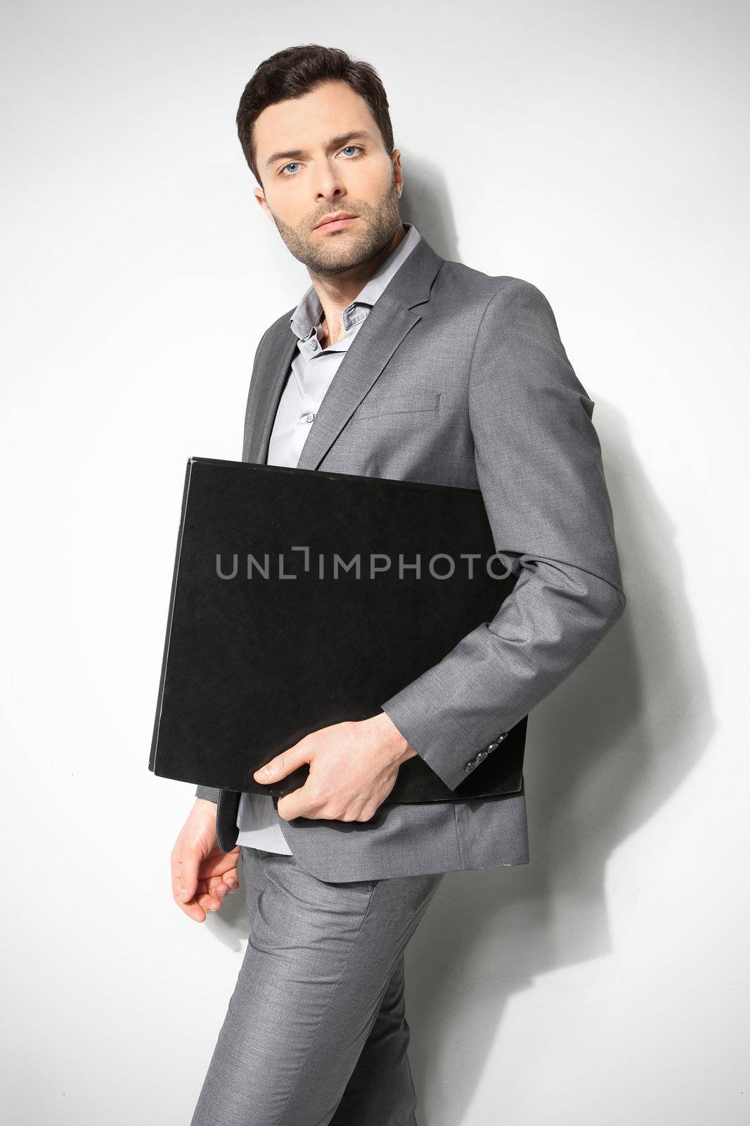 Portrait of a handsome business man ,Isolated on gray by robert_przybysz