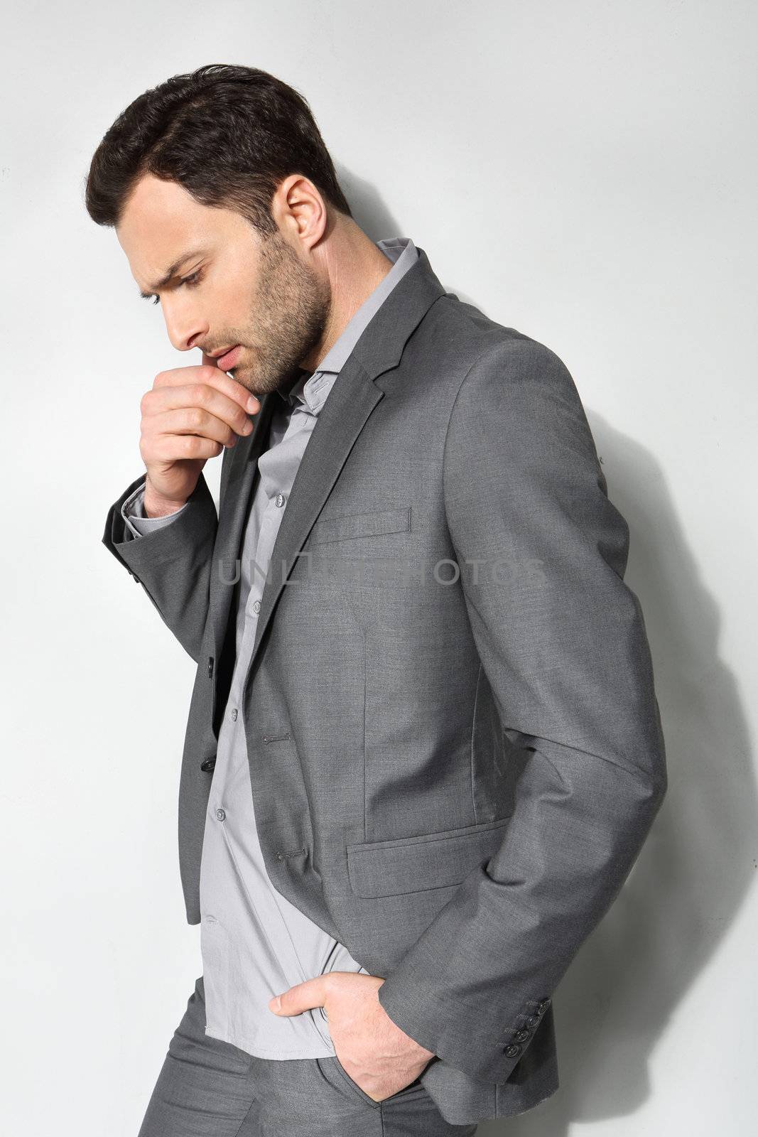 Young stylish man on a gray background by robert_przybysz