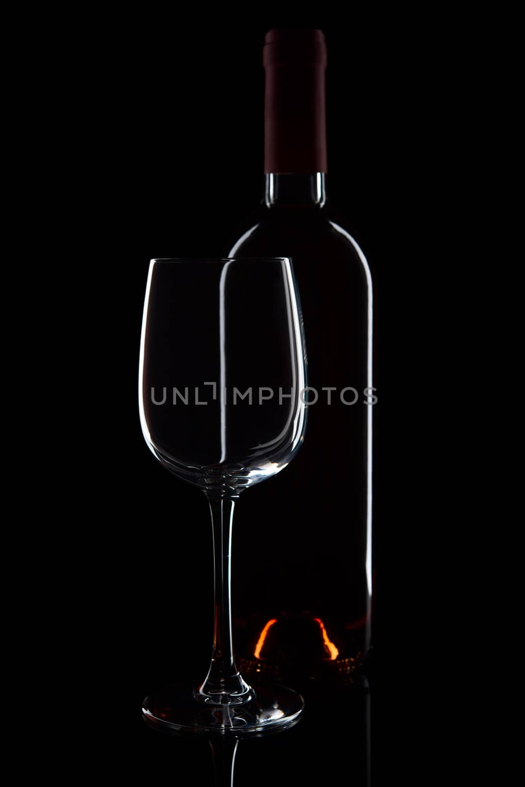 Glass and bottle with red wine