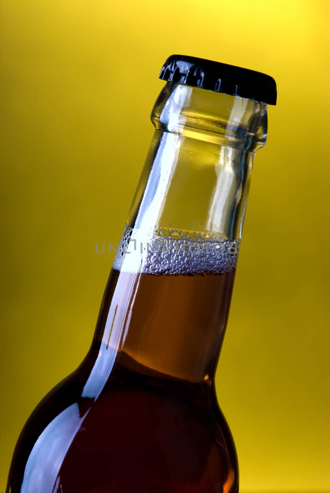Glass bottle on a yellow background .