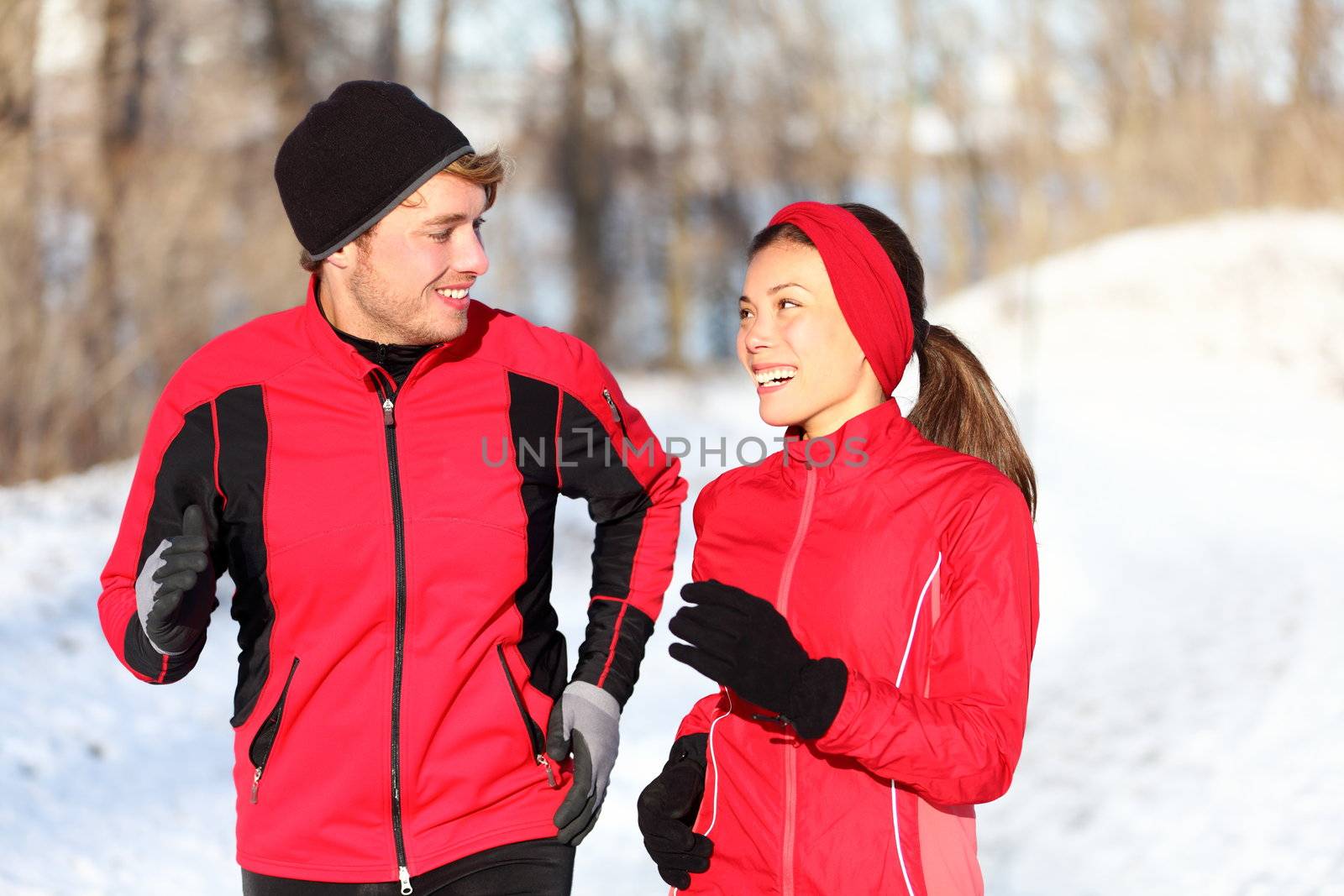 Couple running in winter by Maridav