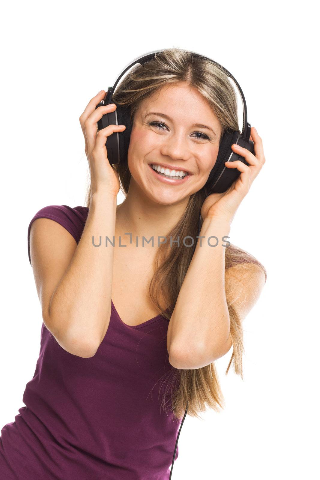 Cheerful young woman listening music with headphones, on white