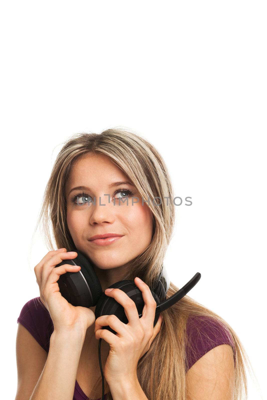 Pretty young woman with earphones looking up, on white