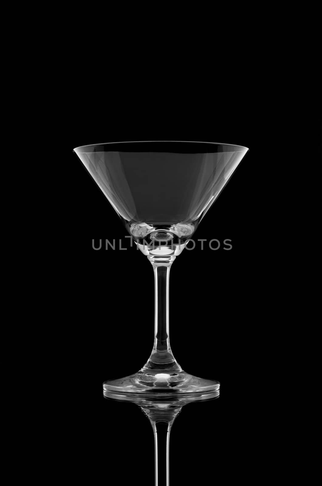 Empty cocktail glass on black background by nuttakit