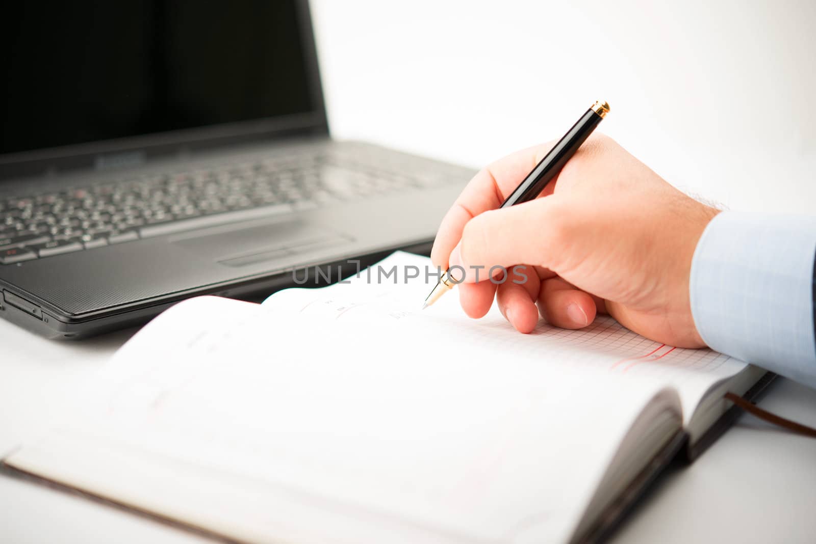 Businessman taking notes and planning in a meeting