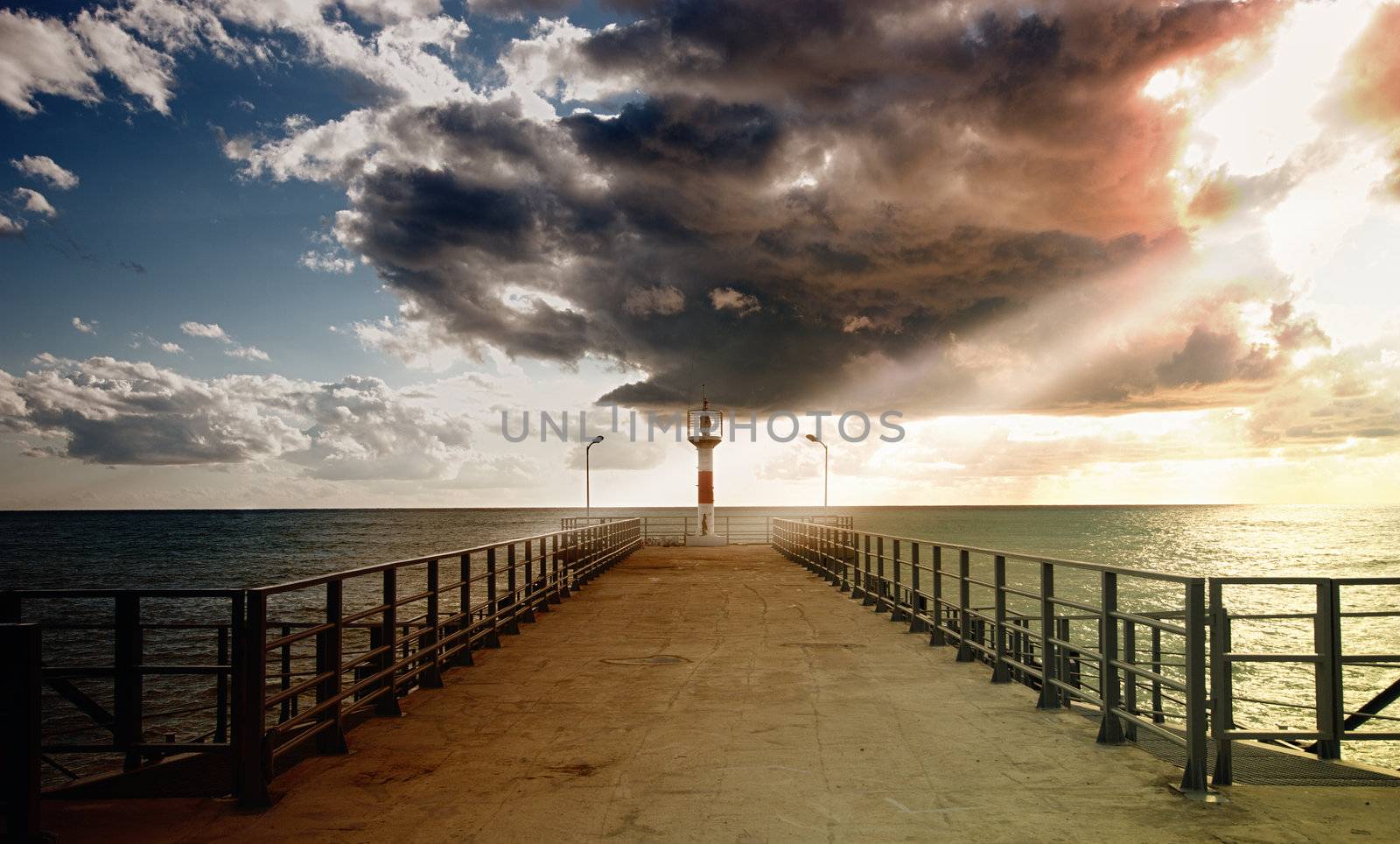 A lighthouse highlighted by the setting sun