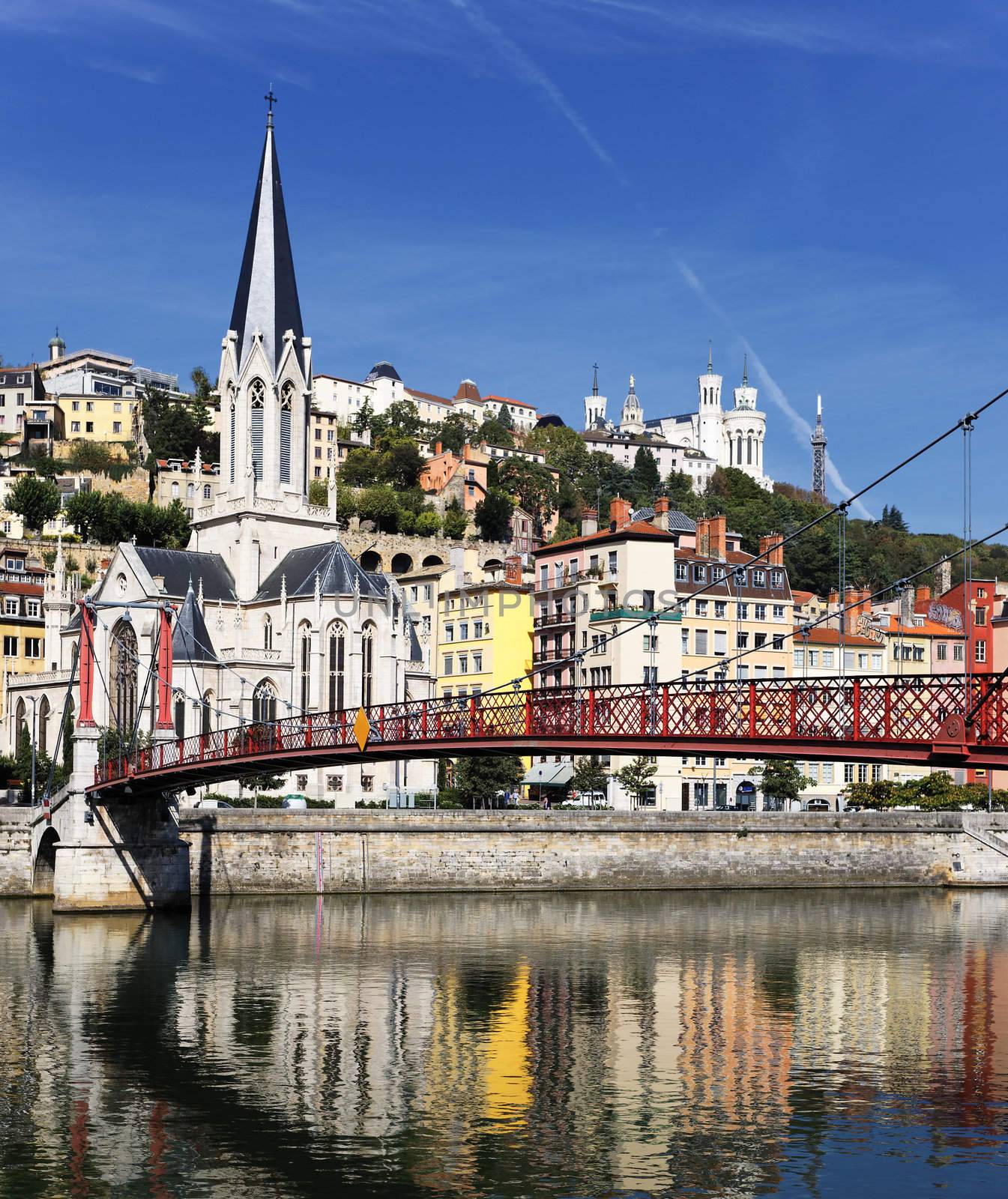 Lyon city with red footbridge on Saone river and church