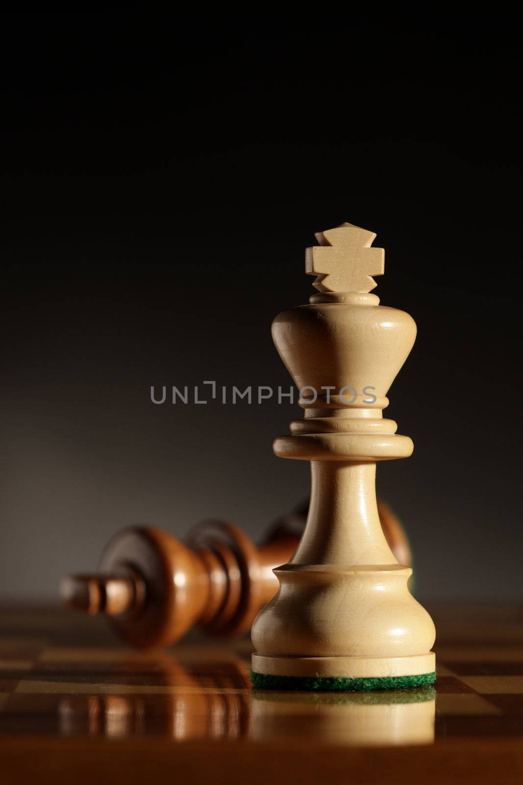 king chess piece with others in background. Low depth of field, focus on foreground.