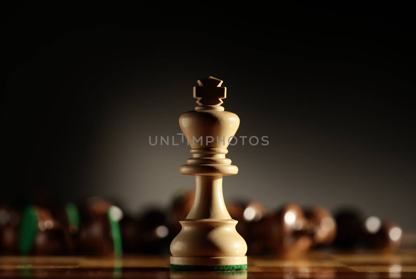 king chess piece with others in background. Low depth of field, focus on foreground.