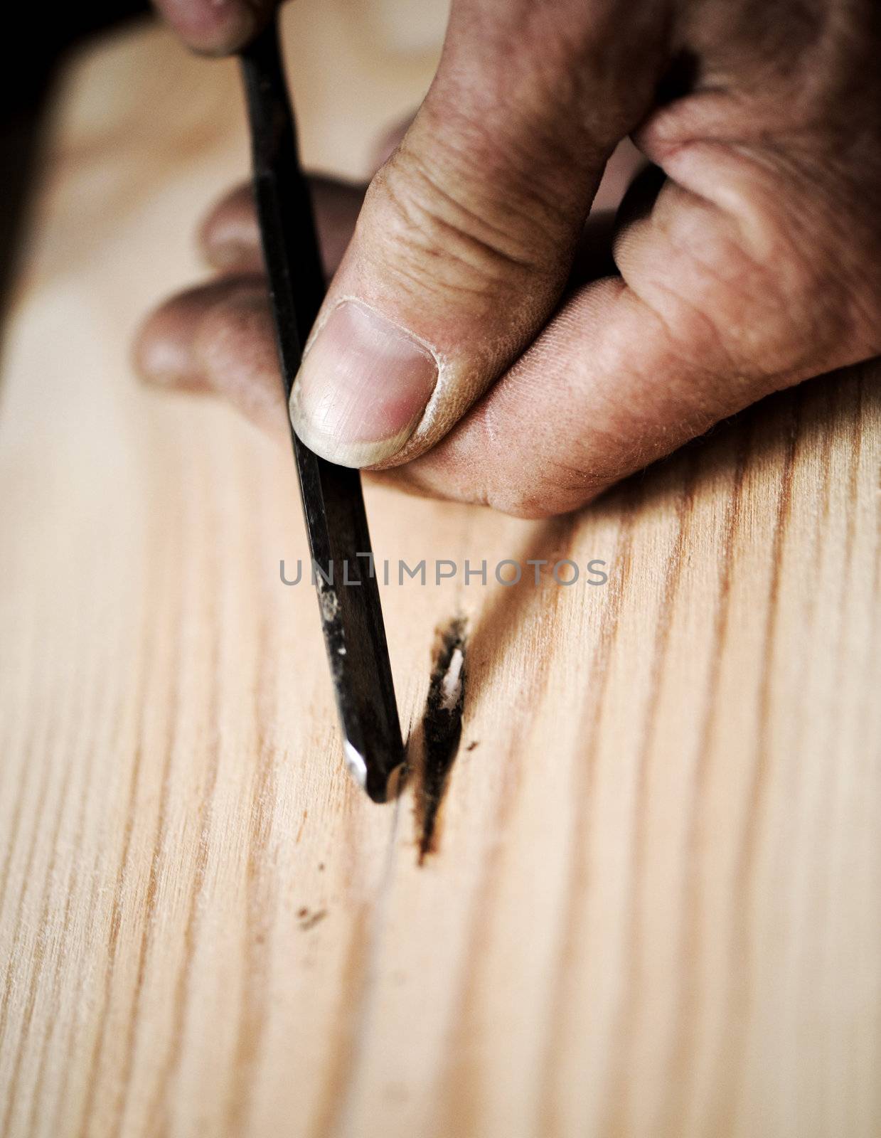 hands of the craftsman carve a bas-relief with a gouge