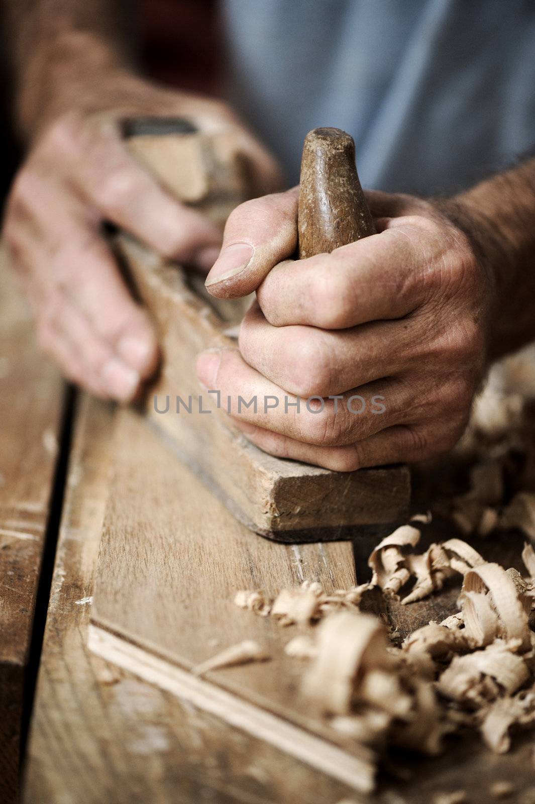 hands of a carpenter, close up by stokkete