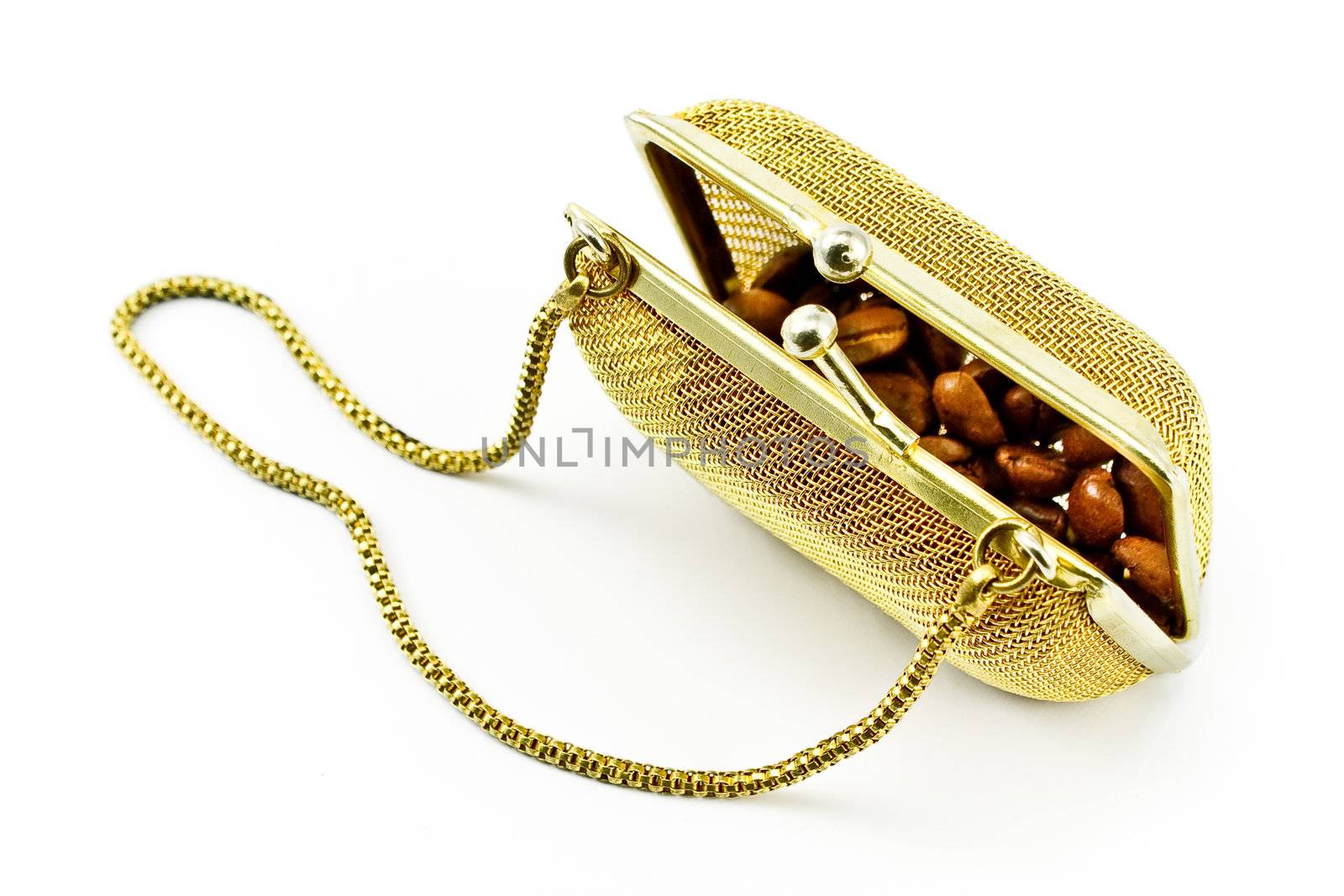 Golden metallic purse with coffee beans isolated on white