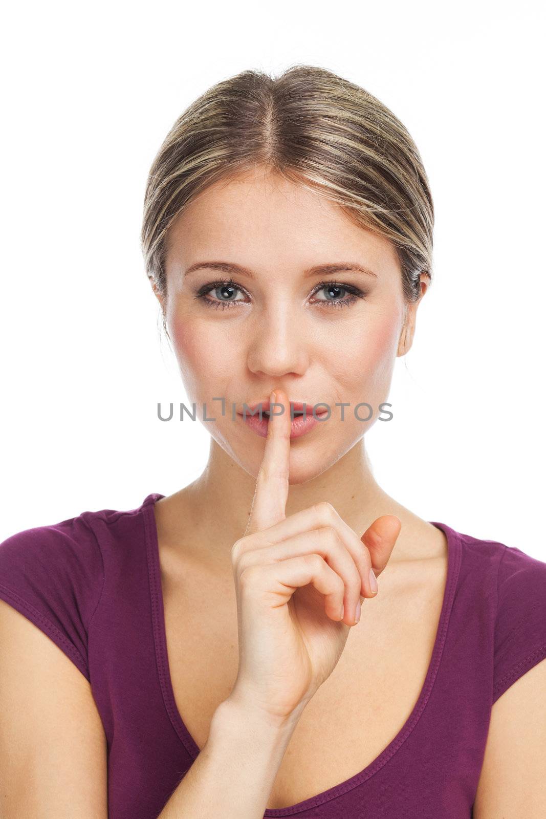 Young woman expressing a desire for silence or secret, on white