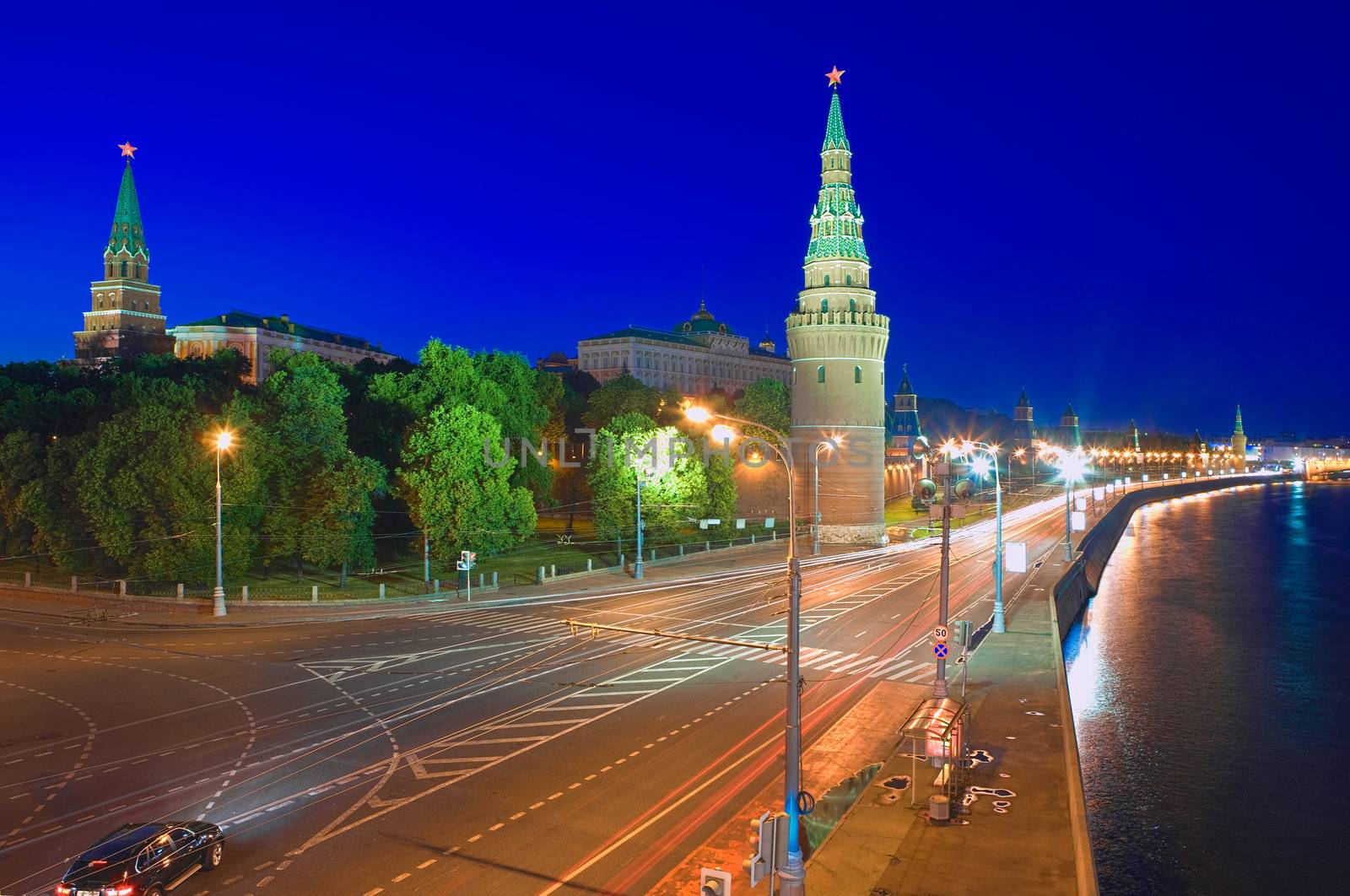 Kremlin embankment of the Moskva River and the Vodovzvodnaya (Water) Tower of the Moscow Kremlin at night. Shot from the Big Stone Bridge. Moscow, Russia.