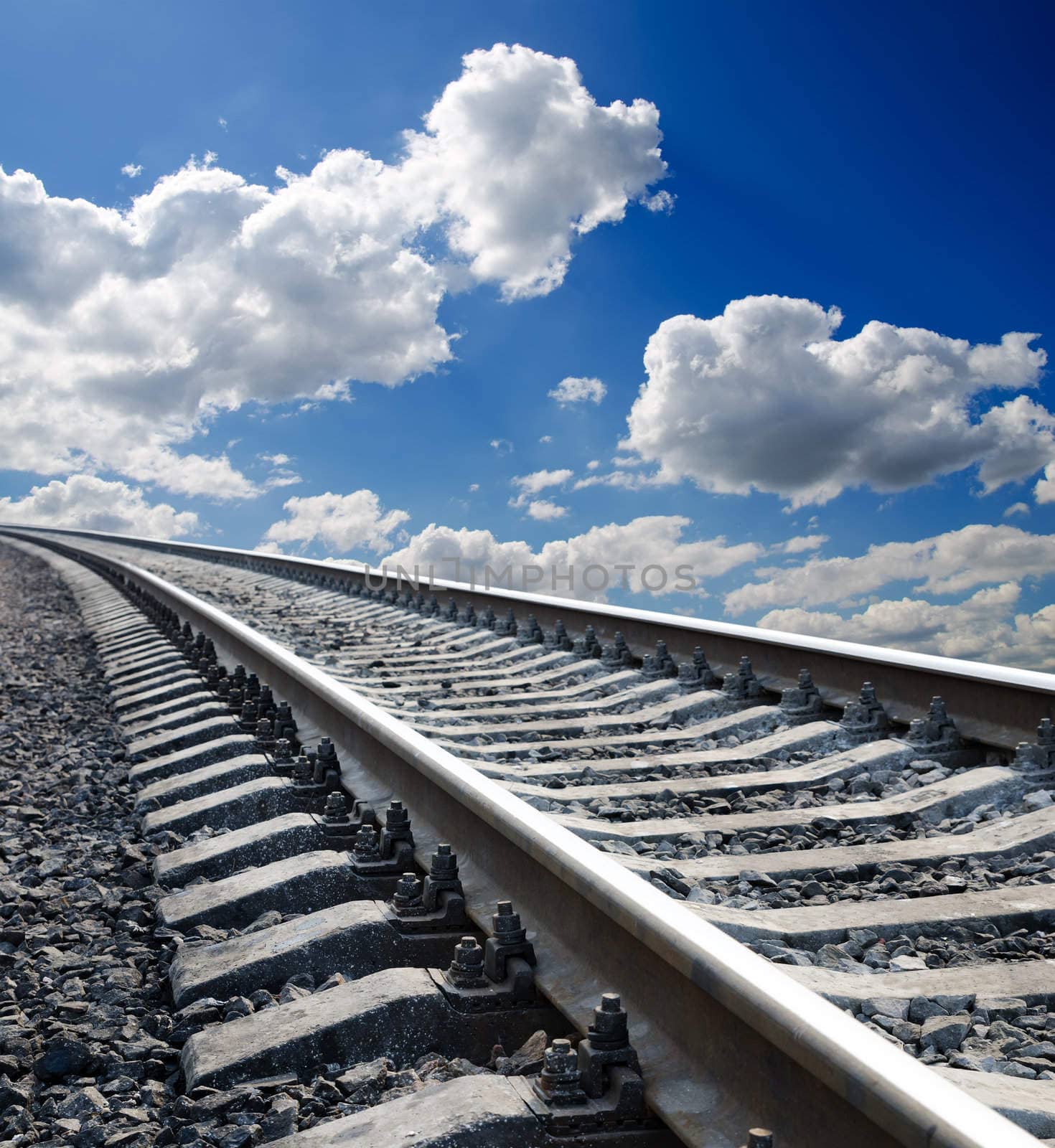 low view to railroad under deep blue cloudy sky by mycola