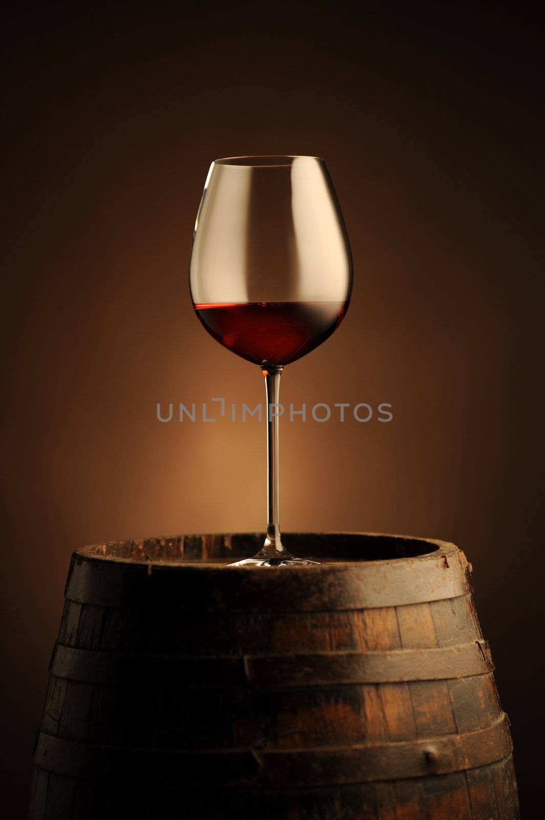 red wine glass  on wodden barrel