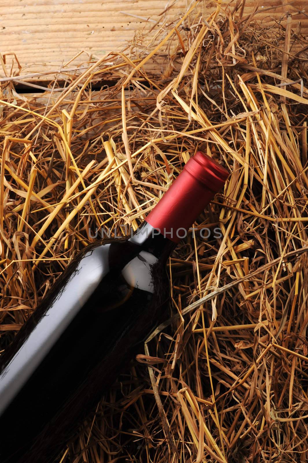 wine bottle on a straw background