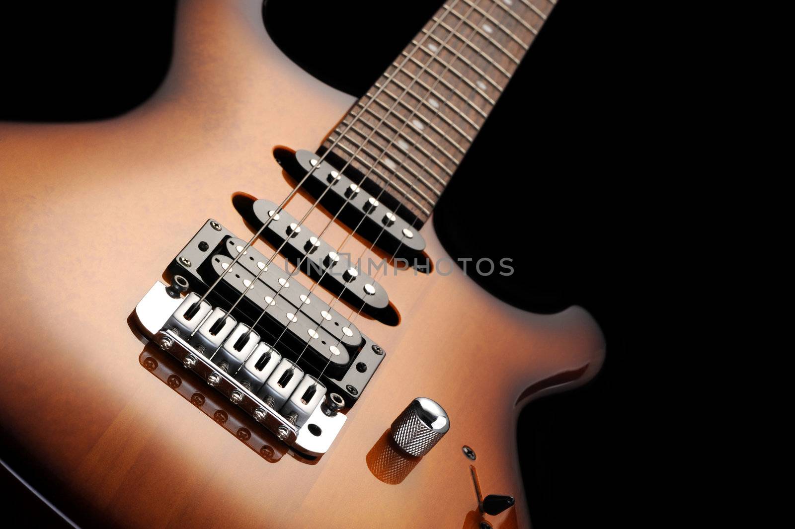  close up of a electric guitar on dark background