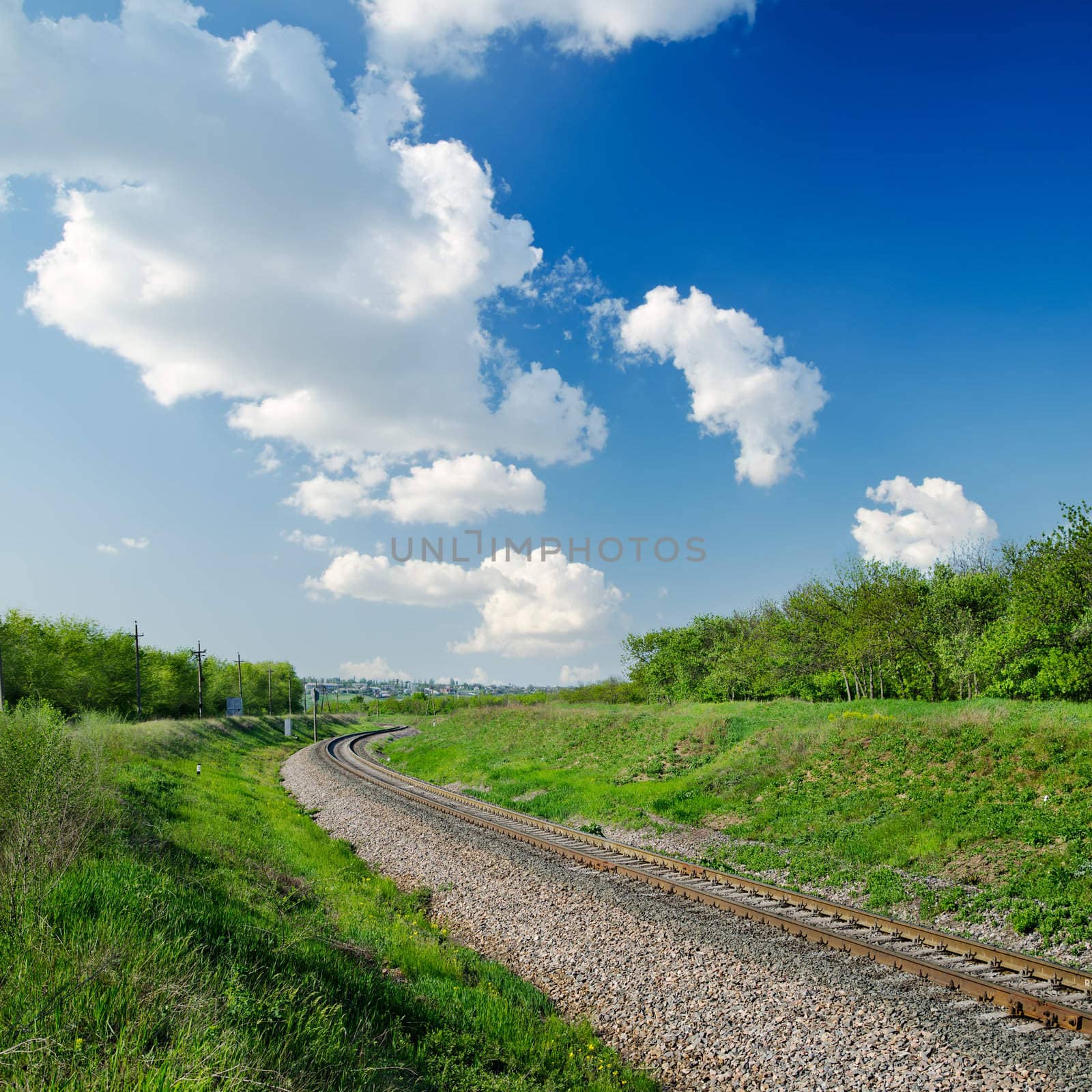 railway goes to horizon in green landscape