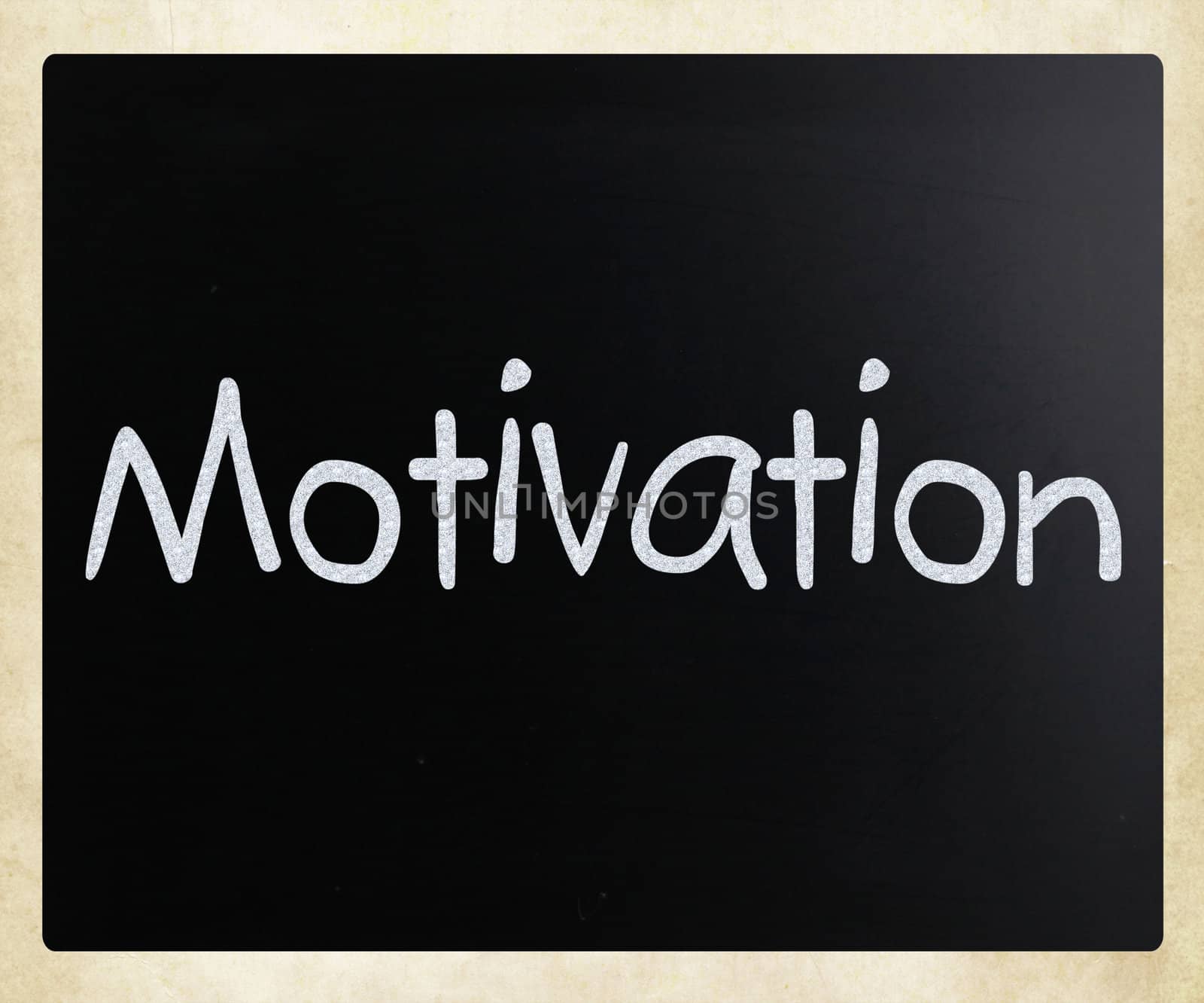 "Motivation" handwritten with white chalk on a blackboard