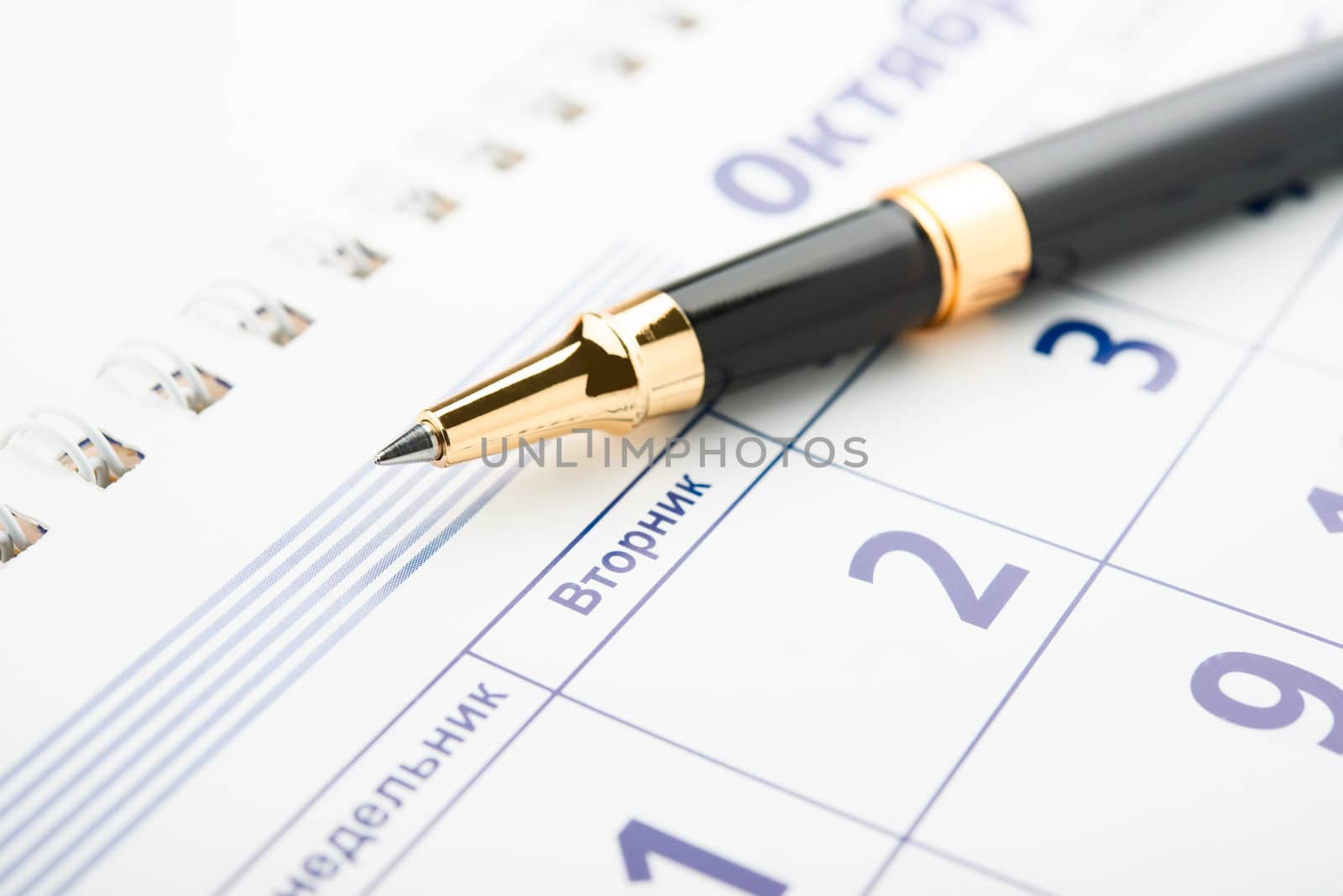 Setting a date. Calendar and pen.