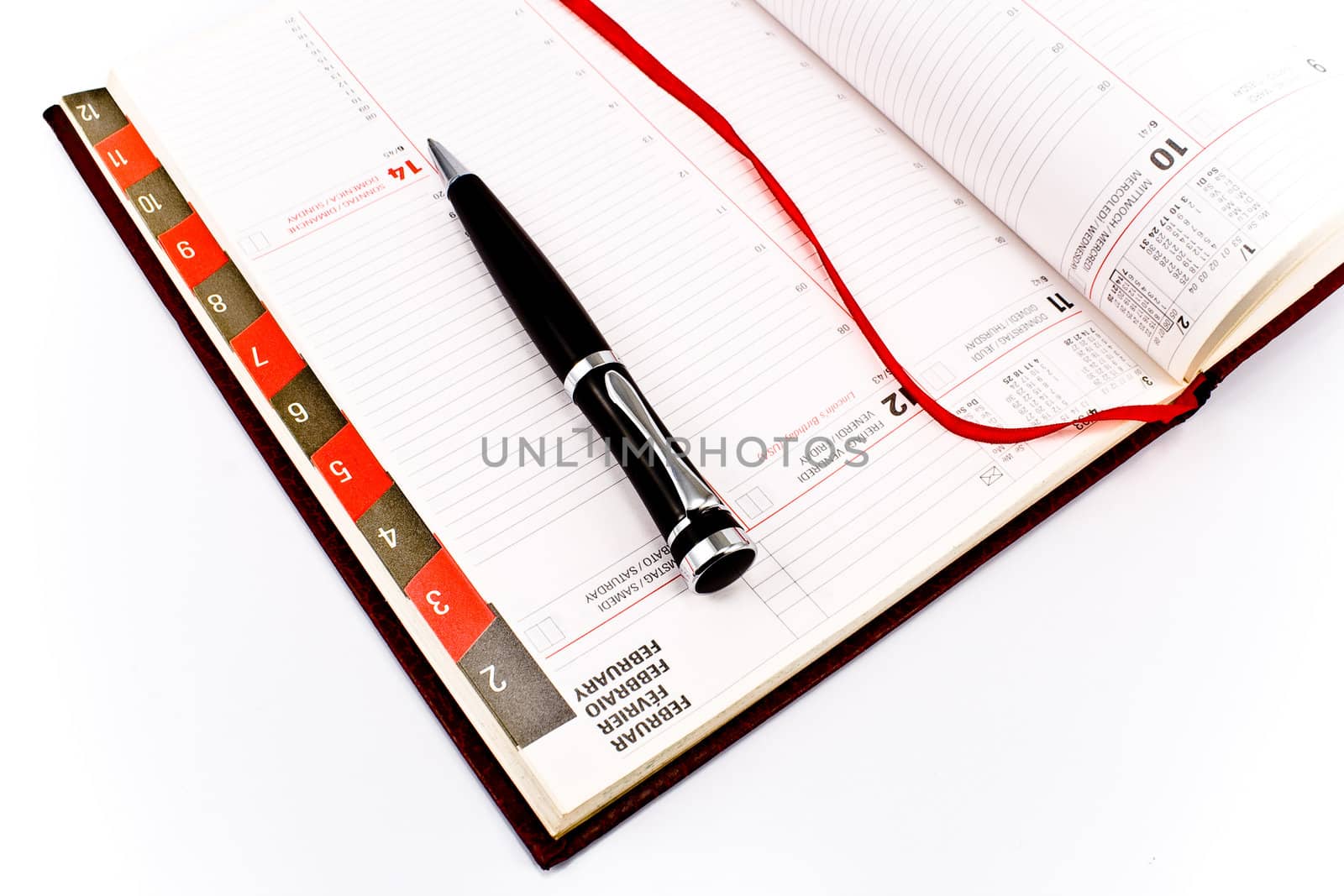 Pen on personal organizer isolated on white