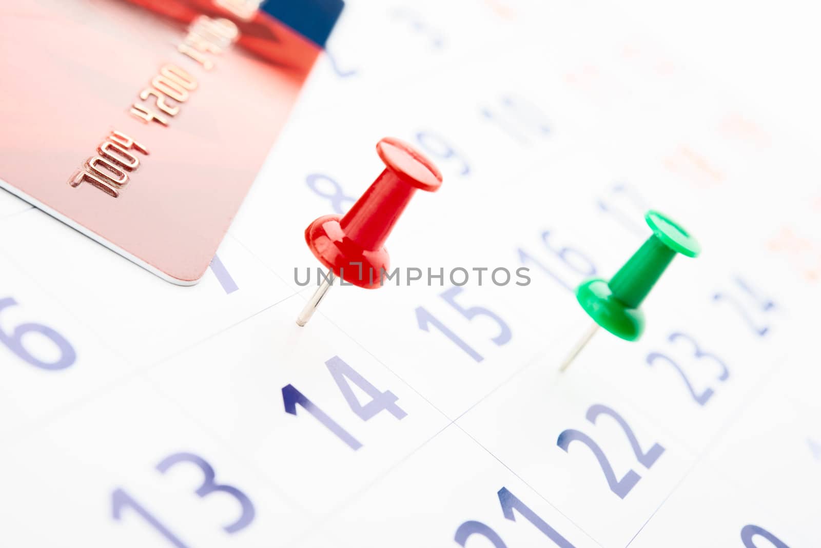 push pin in calendar with credit card