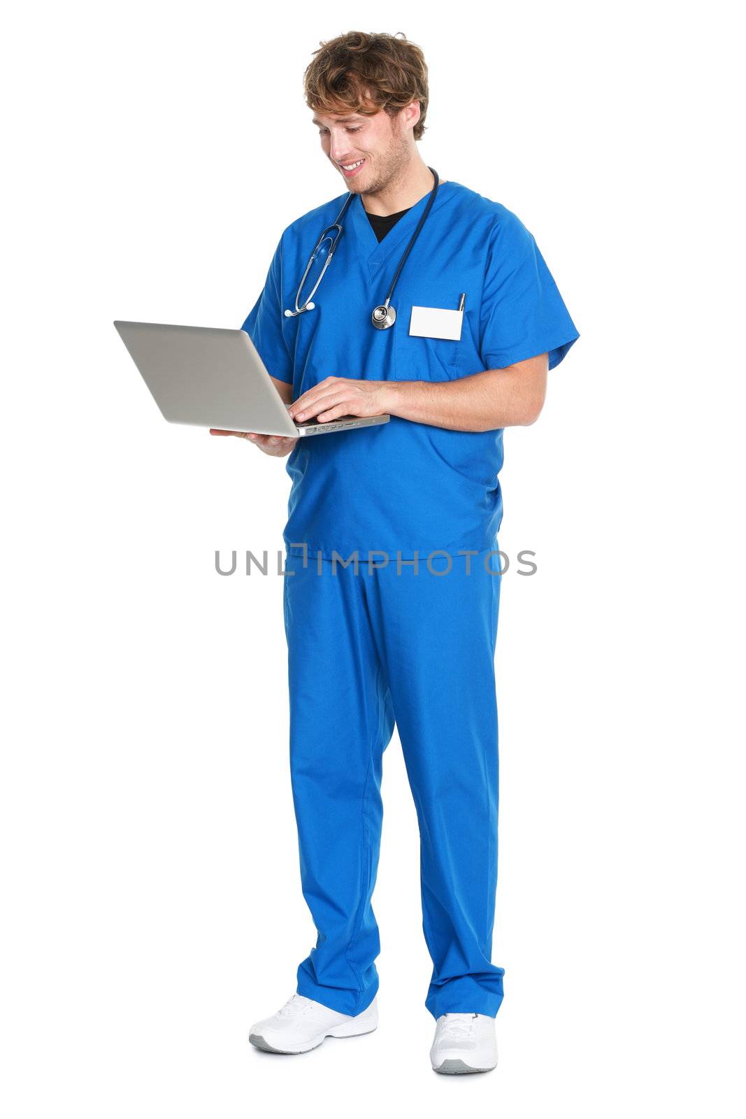 Male Nurse / doctor working on laptop pc computer smiling happy standing isolated in full length on white background. Young medical professional man.