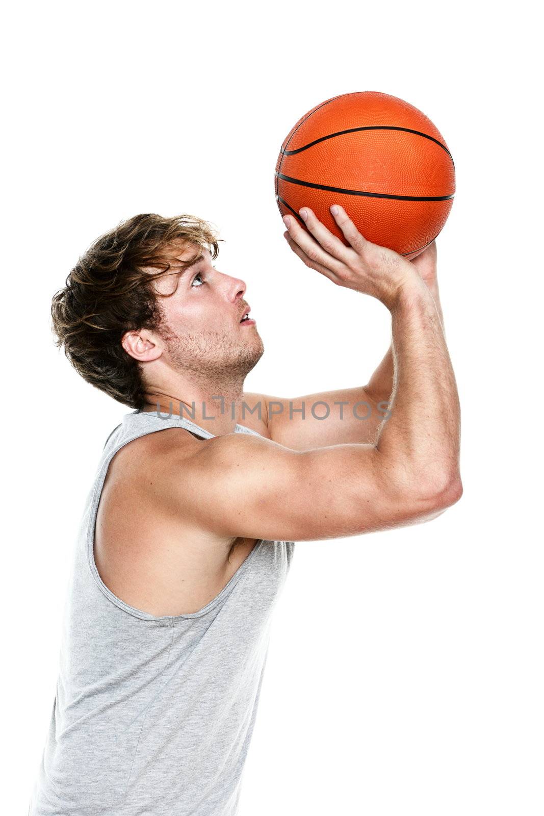 Basketball player shooting isolated on white background. Muscular fit young Caucasian sport fitness model in his 20s.