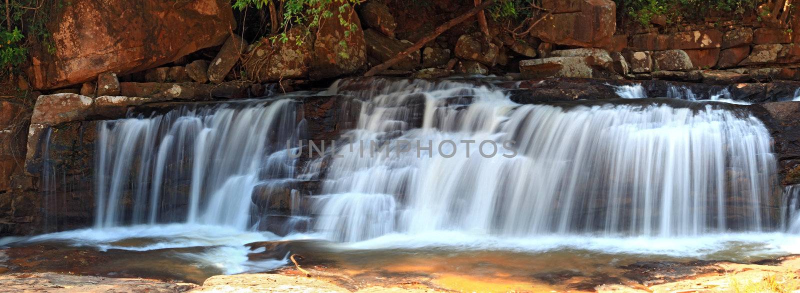 panoramic view of tropical Tadtone waterfall in rain forest by vichie81