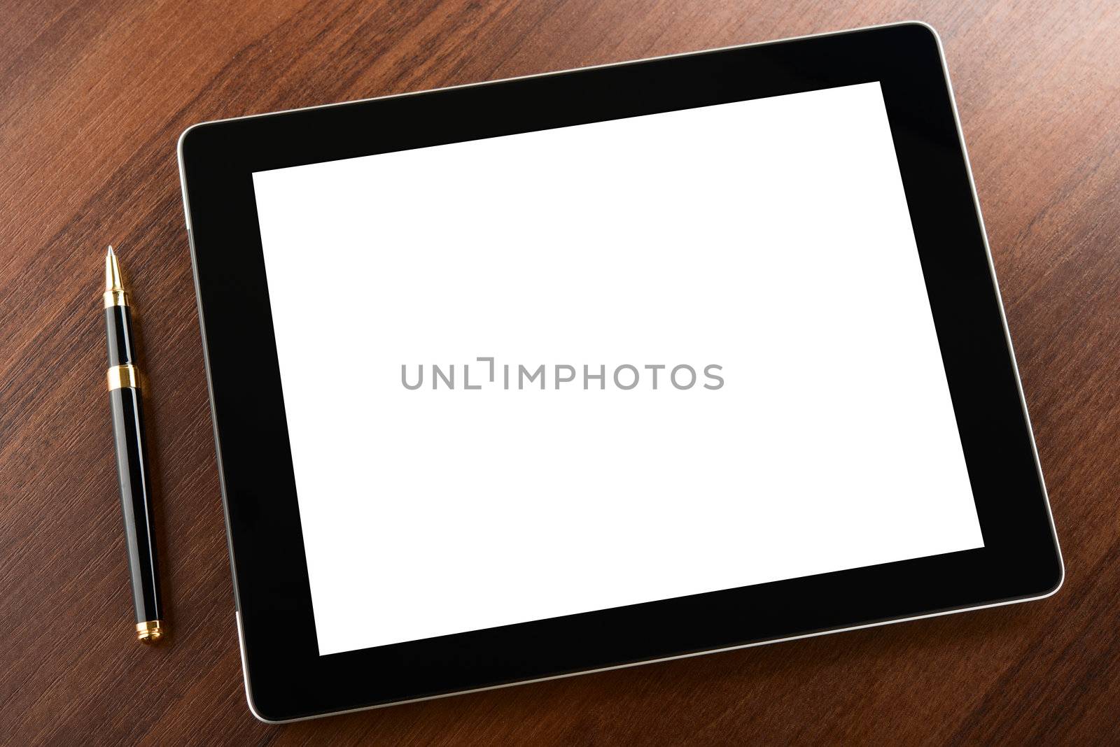 Tablet computer with blank screen on a businessman workplace