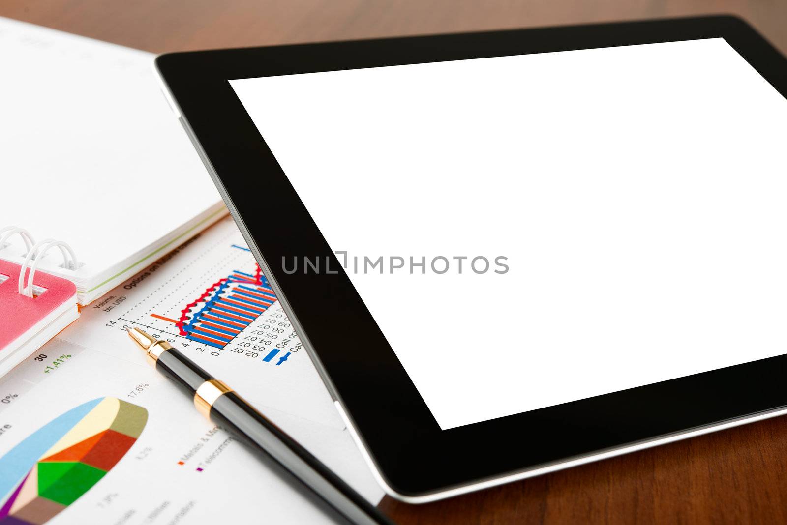 Tablet computer with blank screen on a businessman workplace