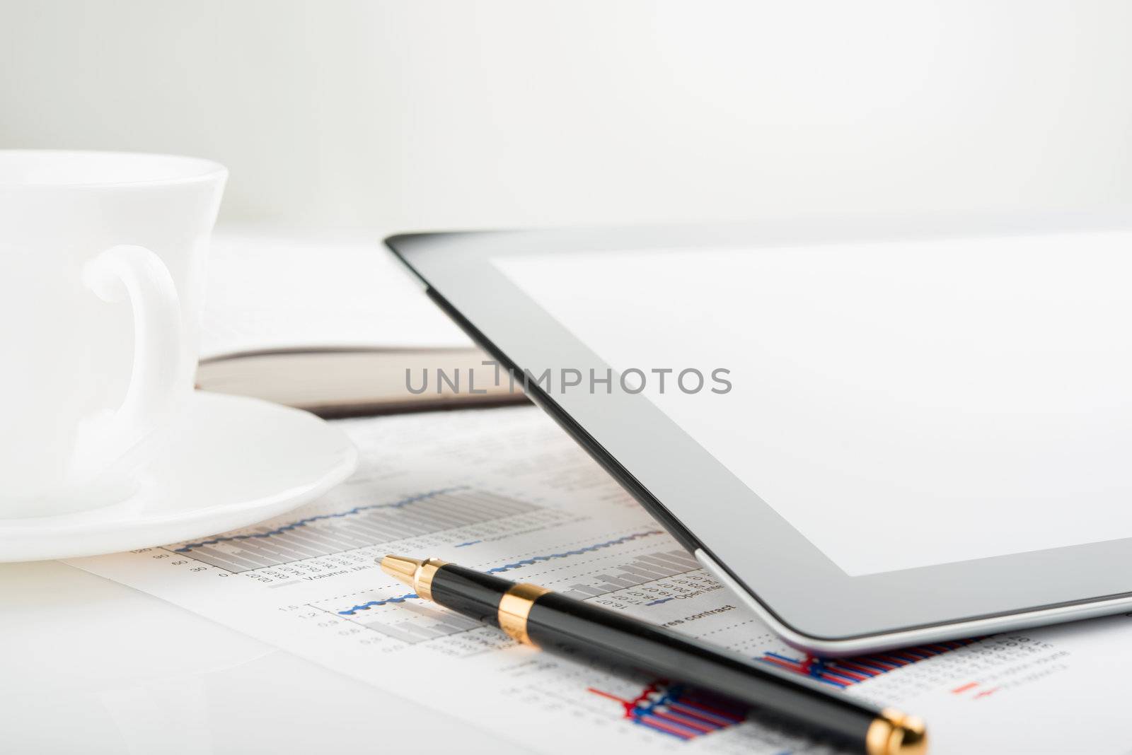 Tablet computer with blank screen on a businessman workplace