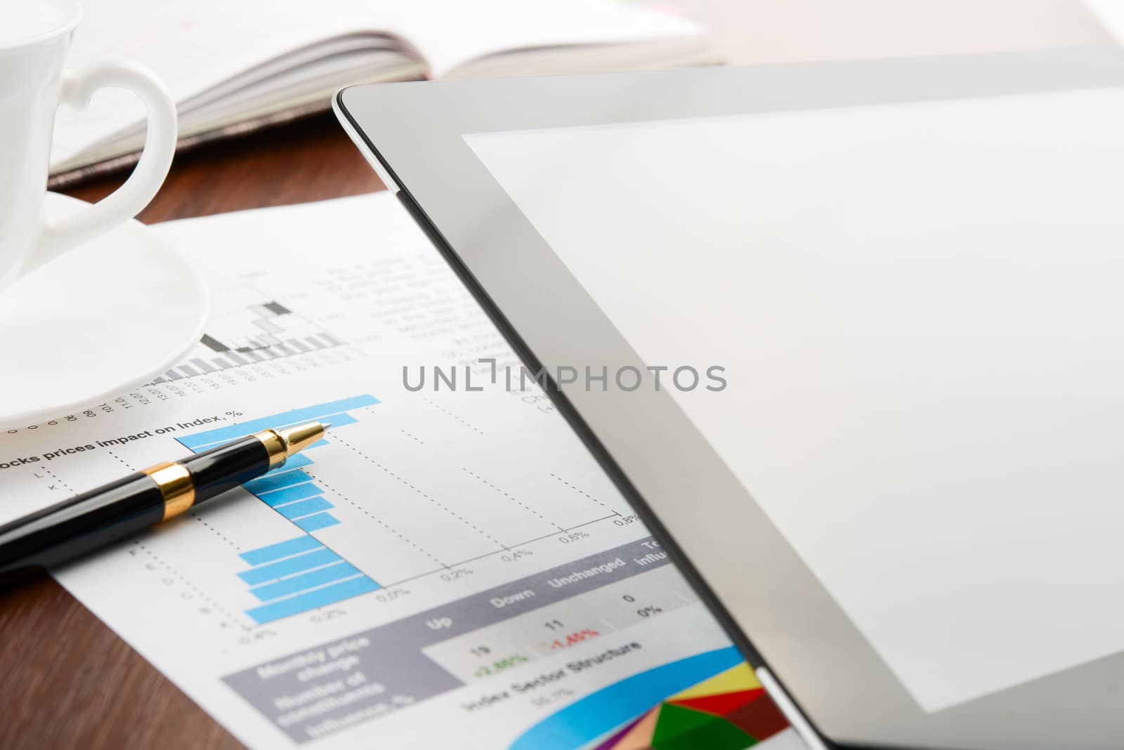 Tablet computer with blank screen on a businessman workplace