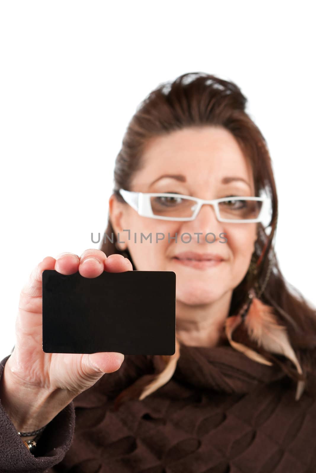Brunette woman holding up a blank credit card business card shoppers club card or gift card of some sort with copyspace. Shallow depth of field.