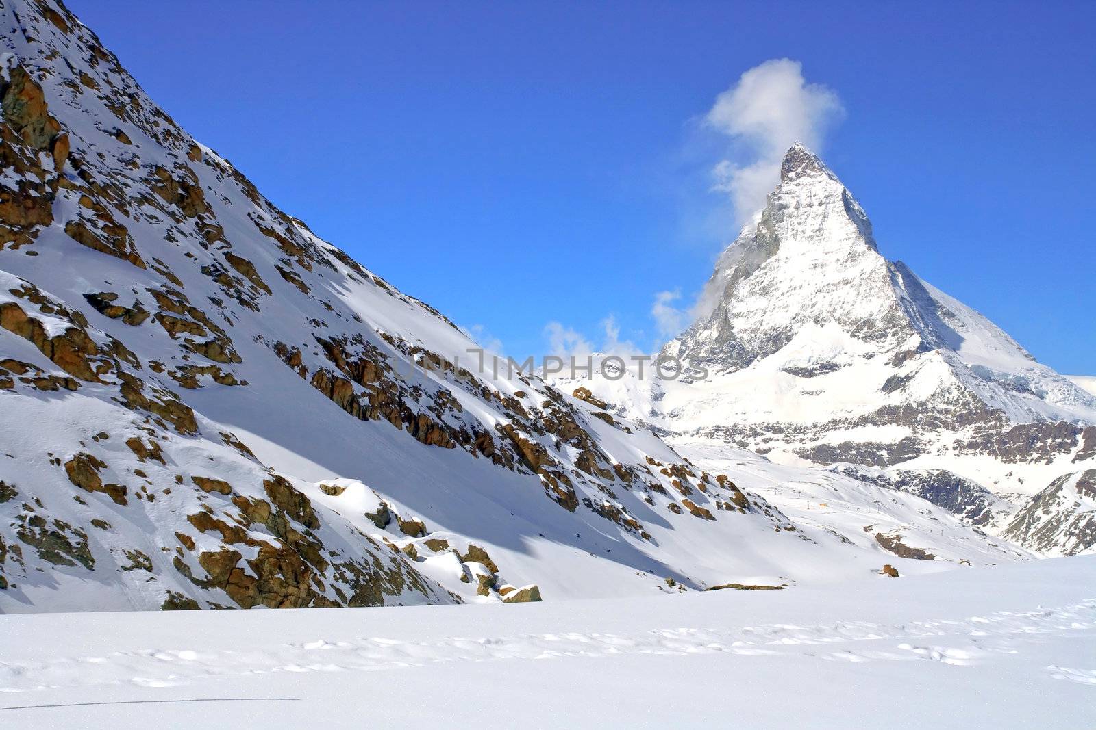 Matterhorn Peak in Swiss Alps with red rock landscape