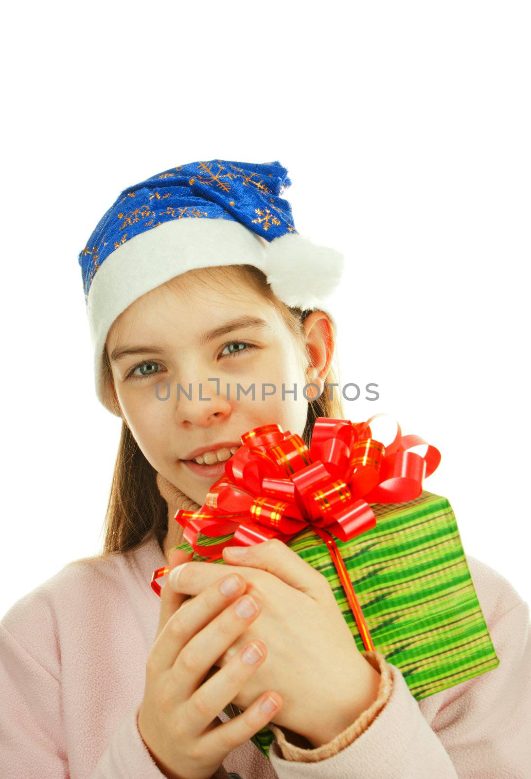 Teen girl wearing Santa hat with a present against white background