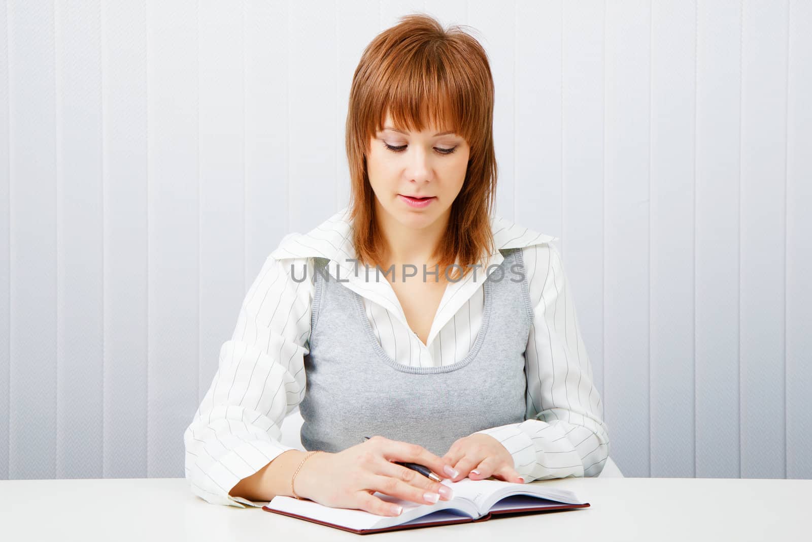 Attractive girl with a notepad and pen