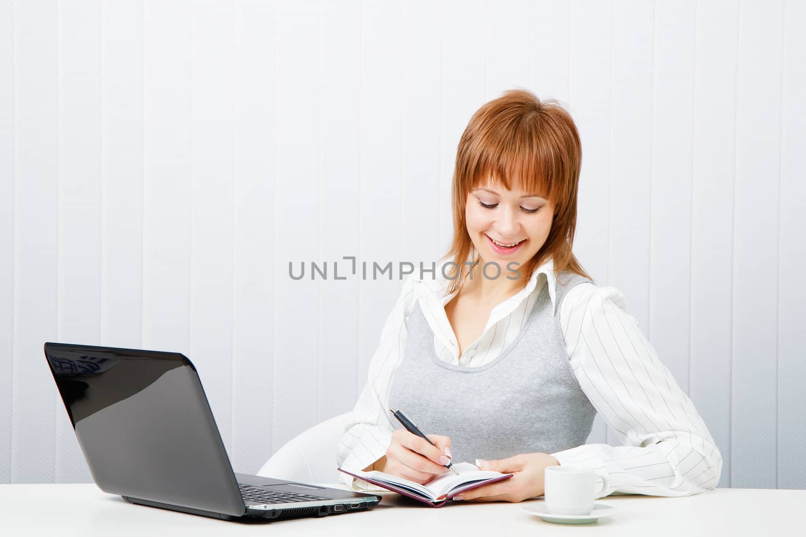 smiling attractive girl with a notebook. Office worker