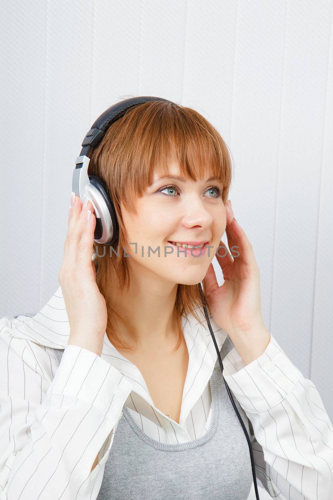 The girl in headphones listens to music with pleasure