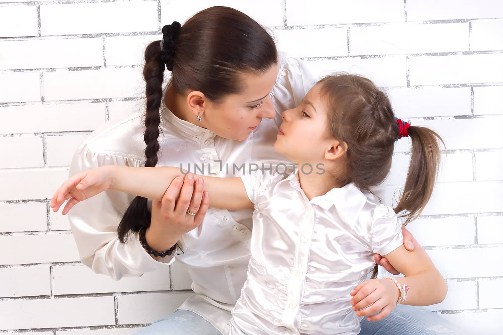 Mum gently kisses his 5 year old daughter