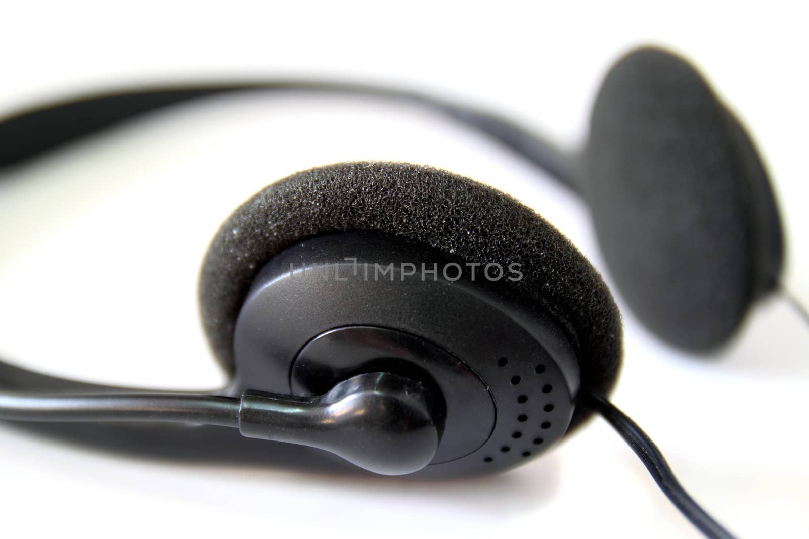 Close up of black headphones isolated on white background by nuchylee