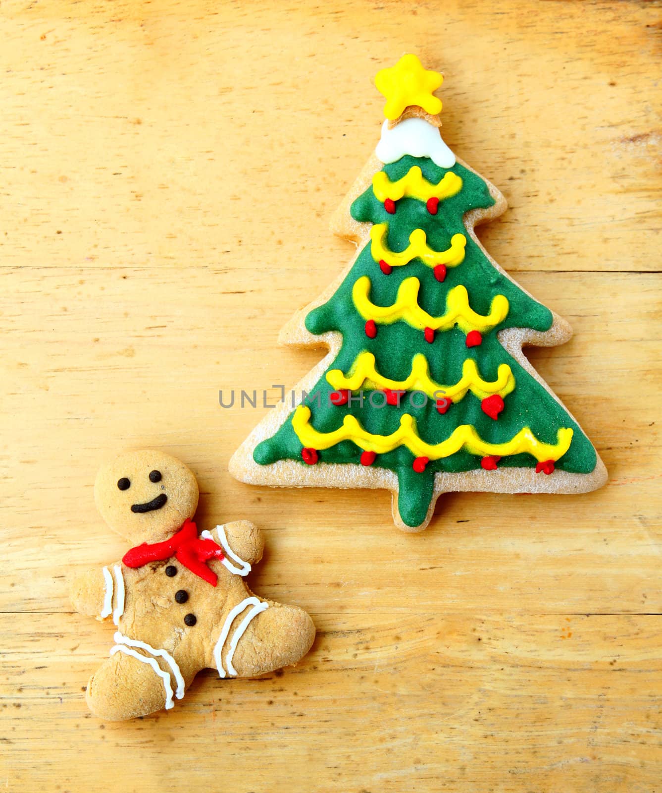 Decorated christmas gingerbreads on wooden background
