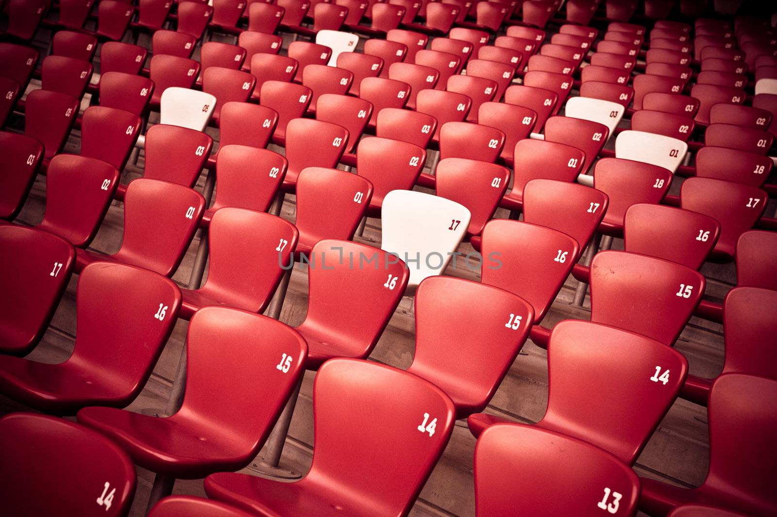 Red and white seats in a sports stadium.
