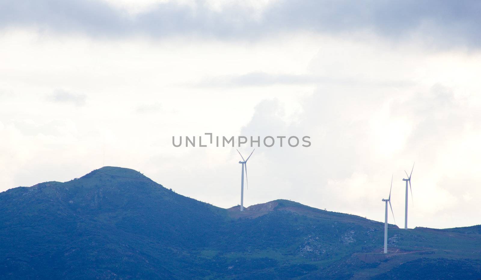 View of Wind turbines in the mountain with clouds
